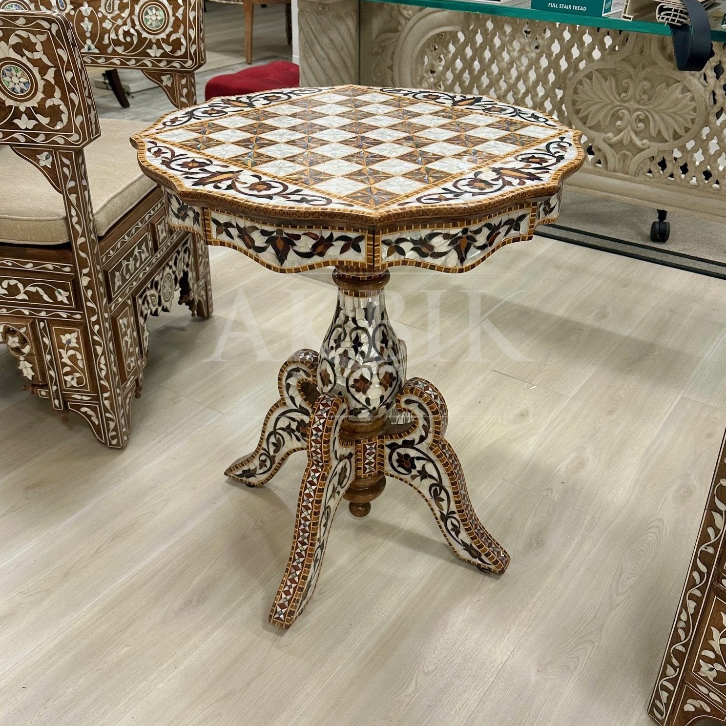 Decorative round table with intricate patterns on a light wood floor.