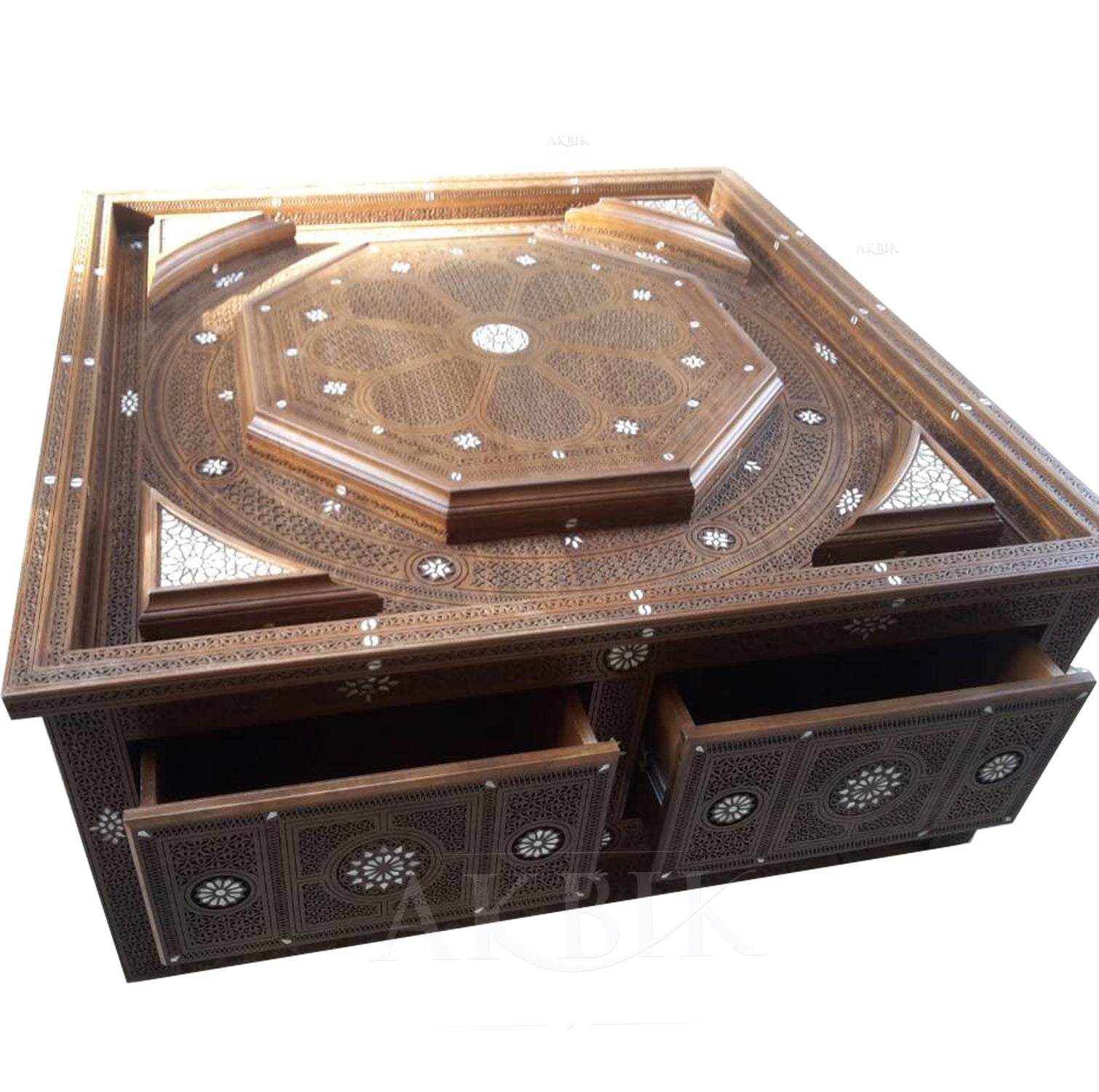 A Levantine-style coffee table with intricate carvings, ornamental inlay details, and storage drawers, finished in a wood with a glass top option.