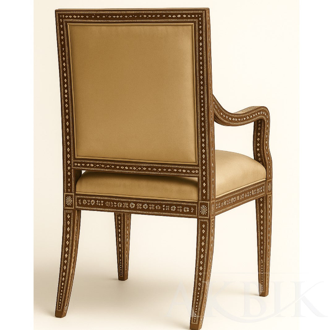 Back of a decorative armchair with intricate designs in mother of pearl inlay and a logo on a beige background