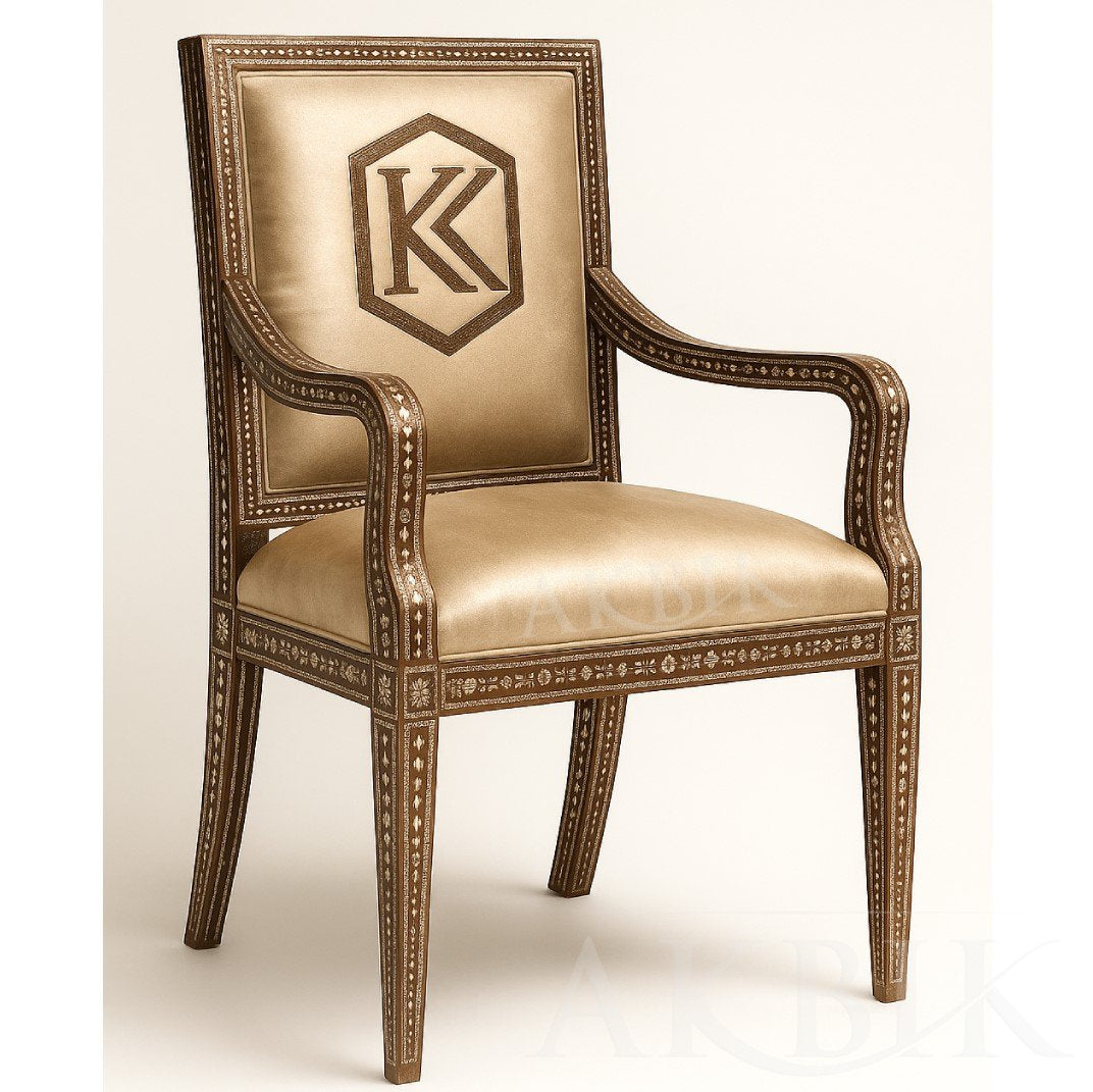Decorative armchair with intricate designs in mother of pearl inlay and a logo on a beige background