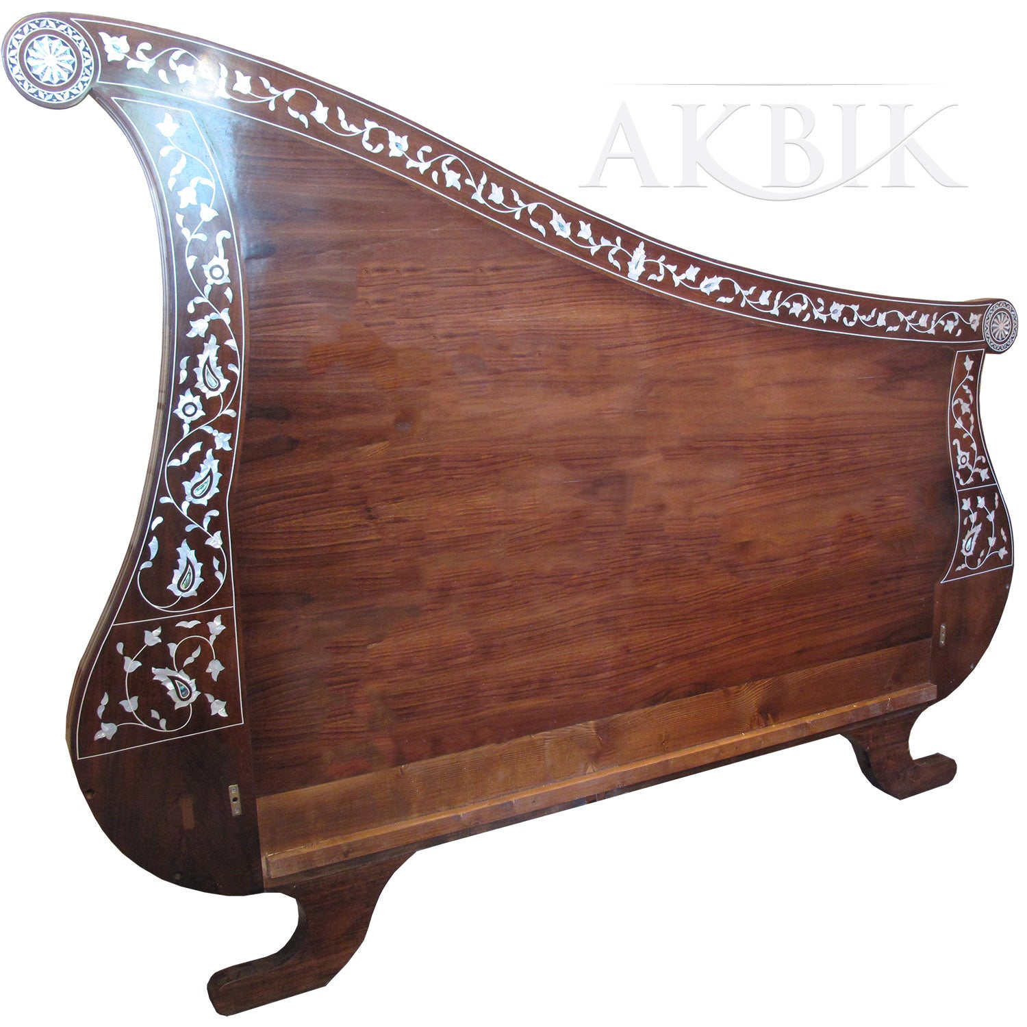 An elegant wooden bed with intricate hand-inlaid mother of pearl and abalone designs on the headboard and footboard, showcasing a harp-inspired silhouette.