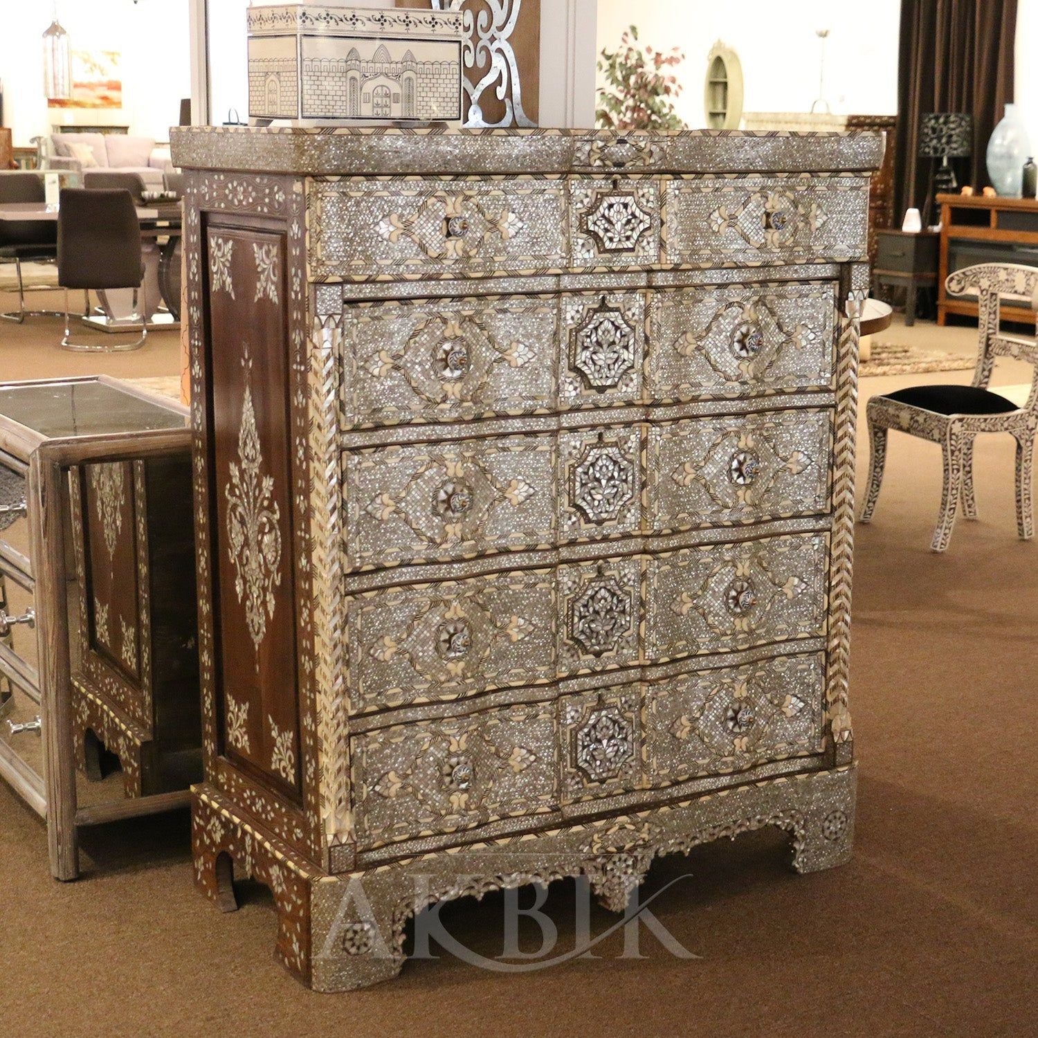 An ornate, antique-style bridal chest with mother-of-pearl detailing and multiple drawers.