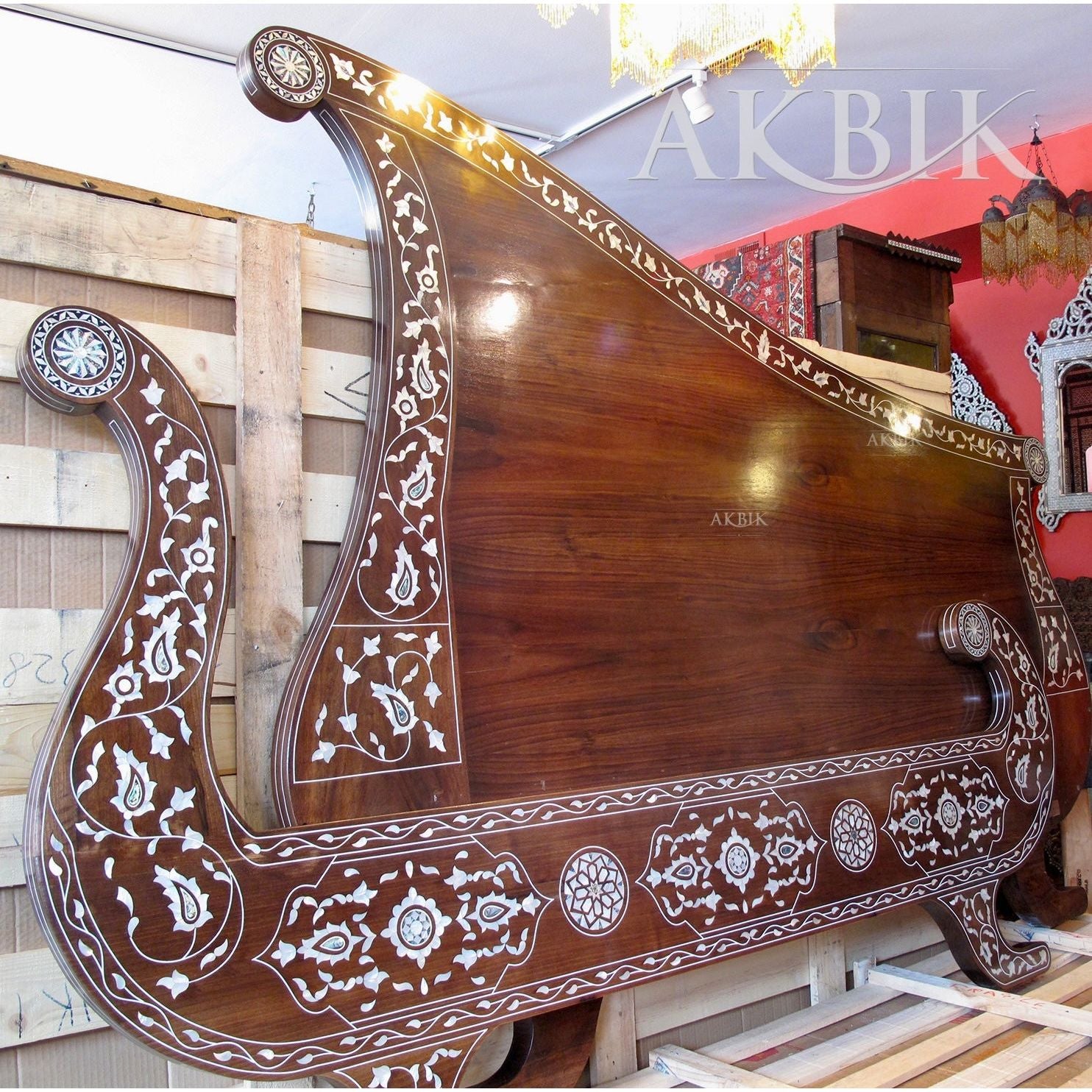 King-size bed with a harp-inspired design, featuring mother of pearl and abalone inlay on a walnut wood frame by Akbik Furniture & design