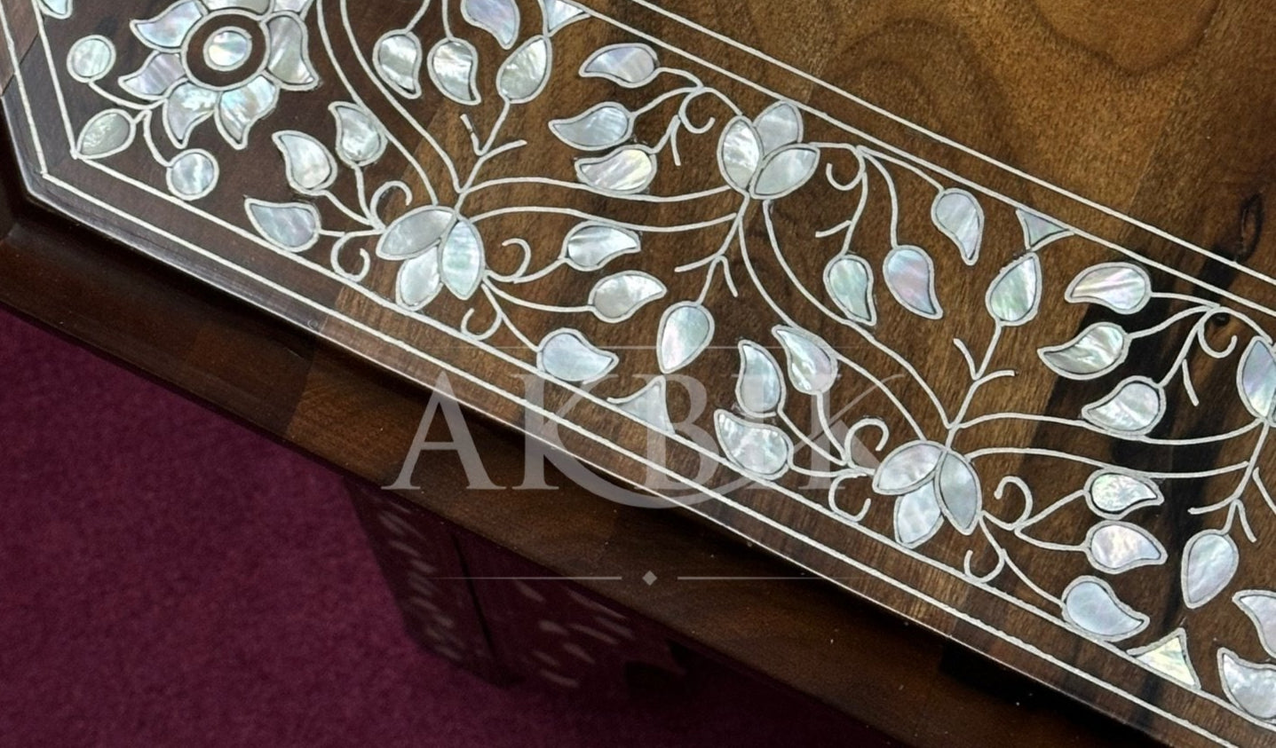 Wooden surface with intricate white floral and leaf patterns