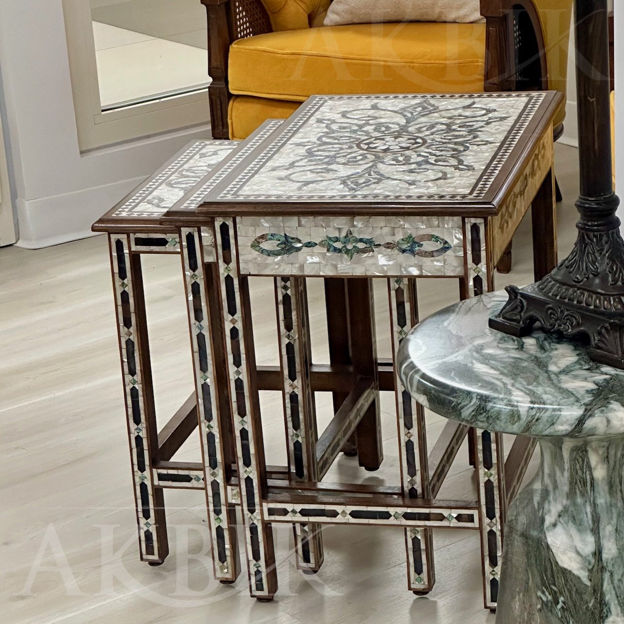 Nesting table set inlaid with floral designs in abalone and mother of pearl