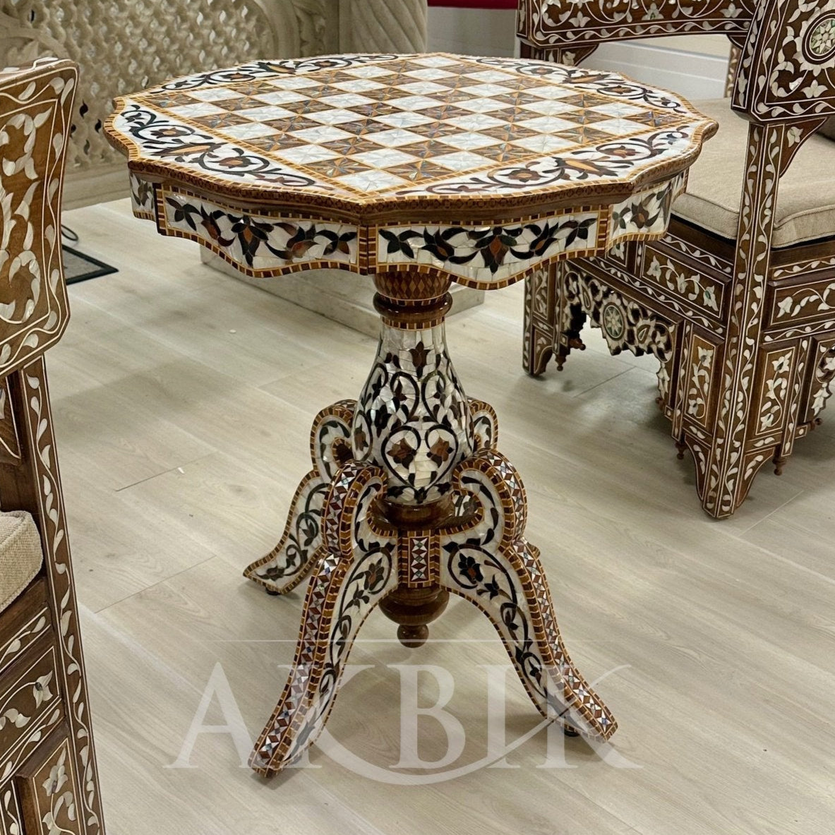 Decorative table and chairs with intricate patterns in a room setting.