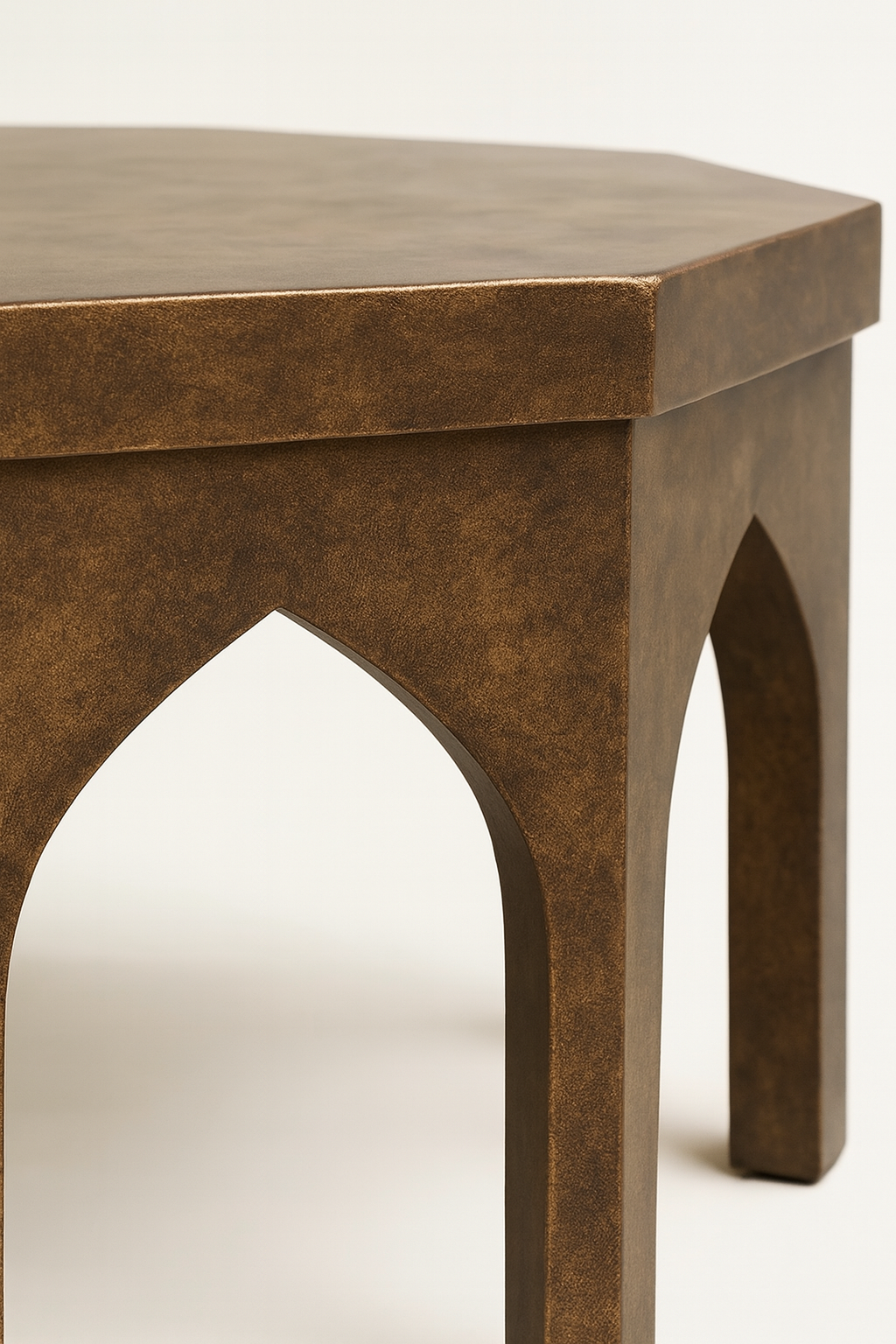 Brown wooden stool with arch-shaped legs on a white background