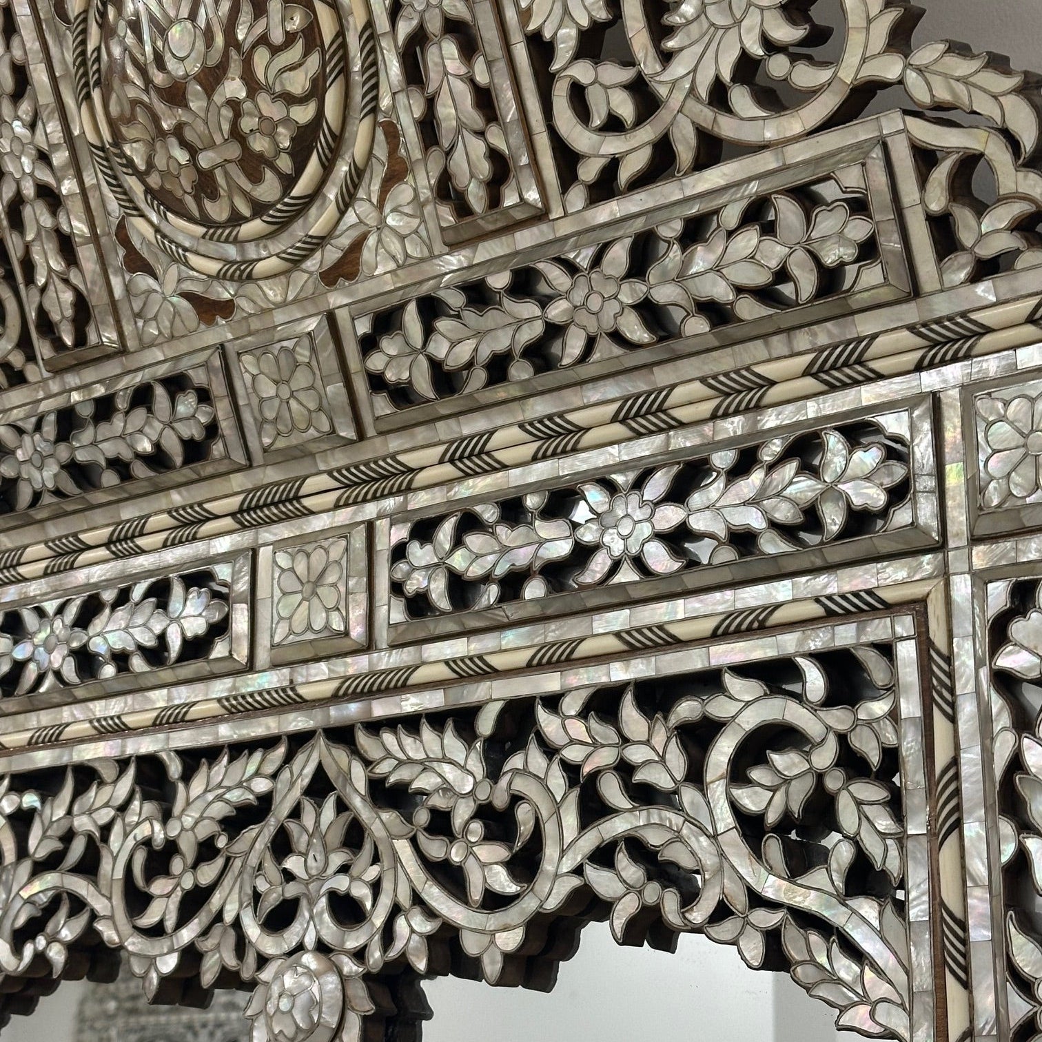 Decorative mirror with intricate floral patterns and bevelled glass
