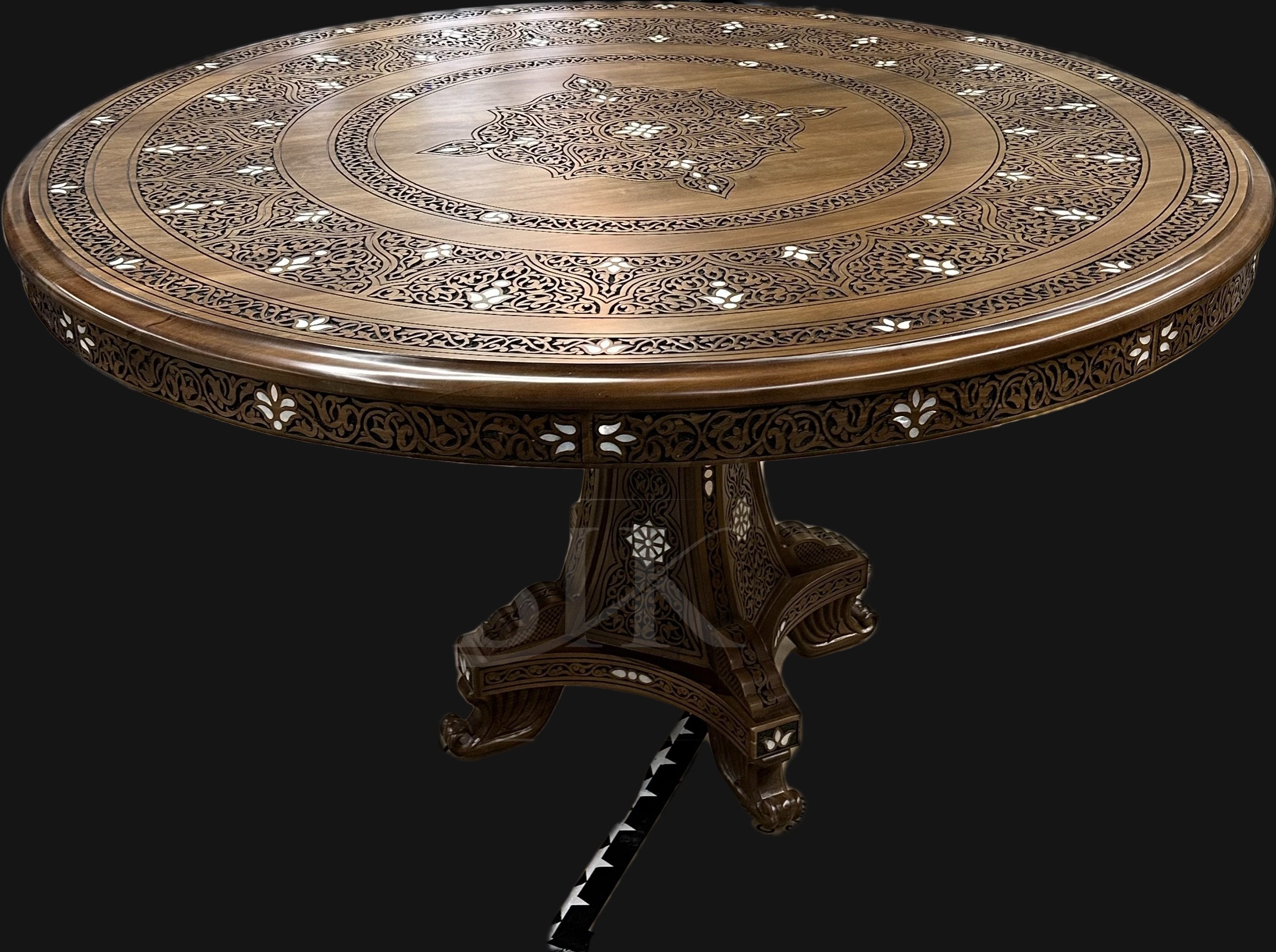 Decorative wooden table with intricate carvings on a black background