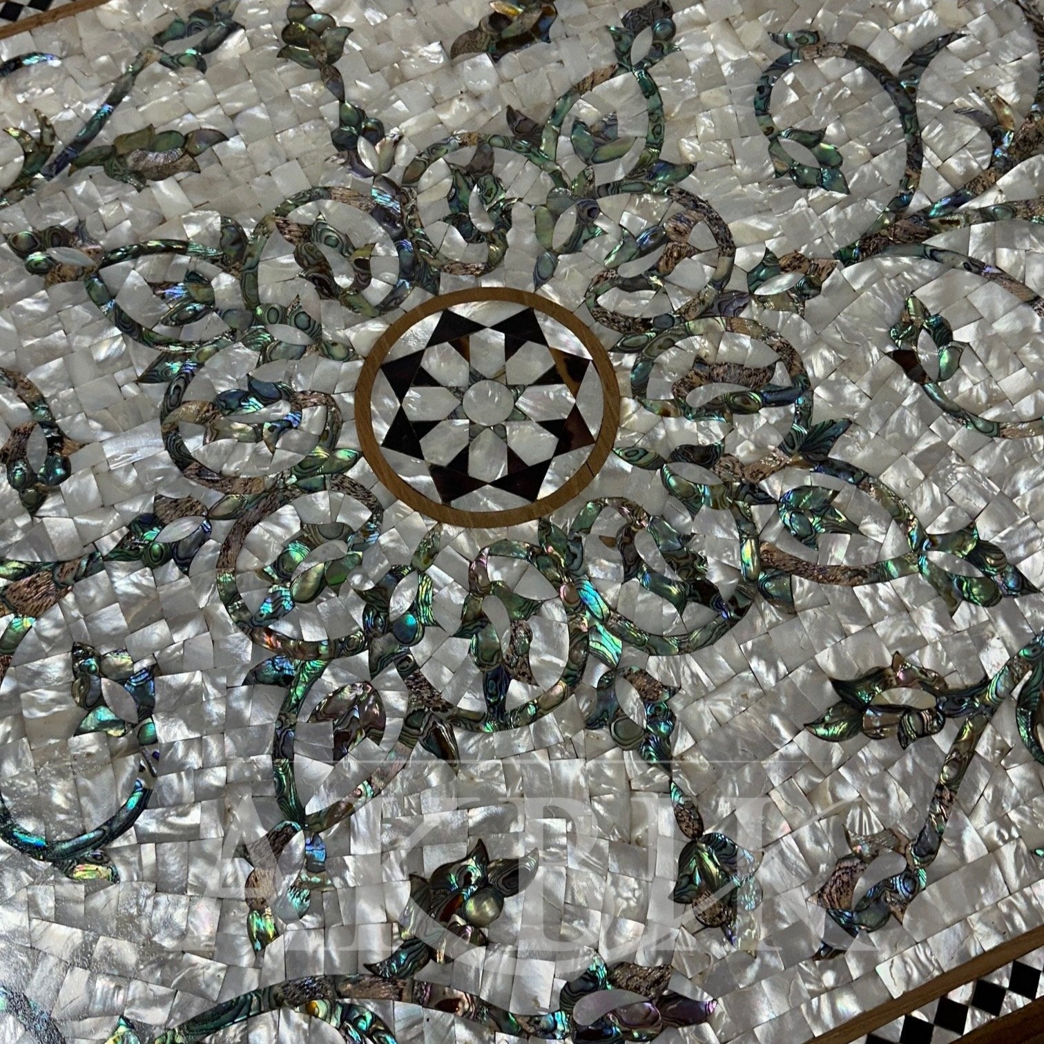 Decorative mosaic table top with intricate patterns and a central design.
