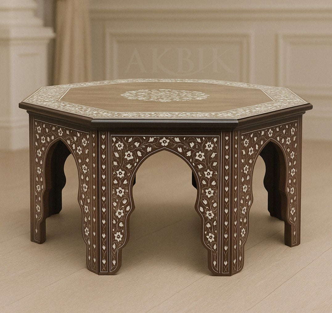 An octagonal coffee table with a walnut wood base and hand-inlaid mother-of-pearl in floral and geometric motifs.