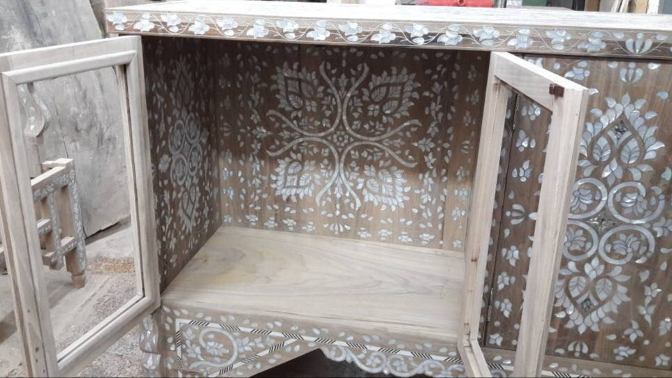 Decorative wooden cabinet with intricate carvings on a blurred background