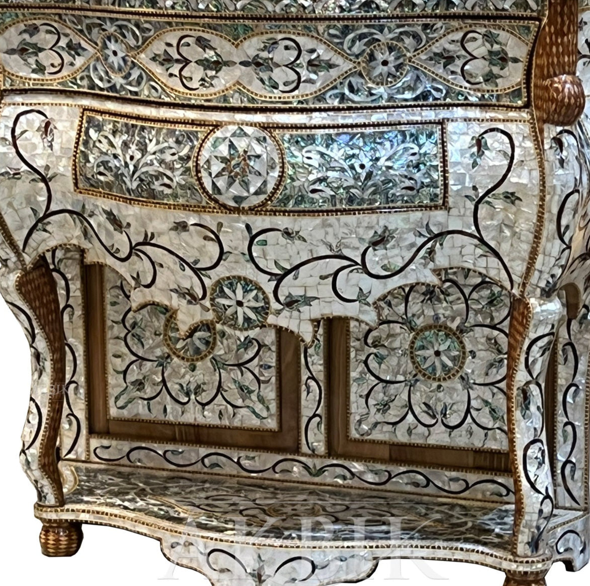 An ornate console table with floral inlays made of abalone and mother of pearl, featuring a baroque-inspired design.