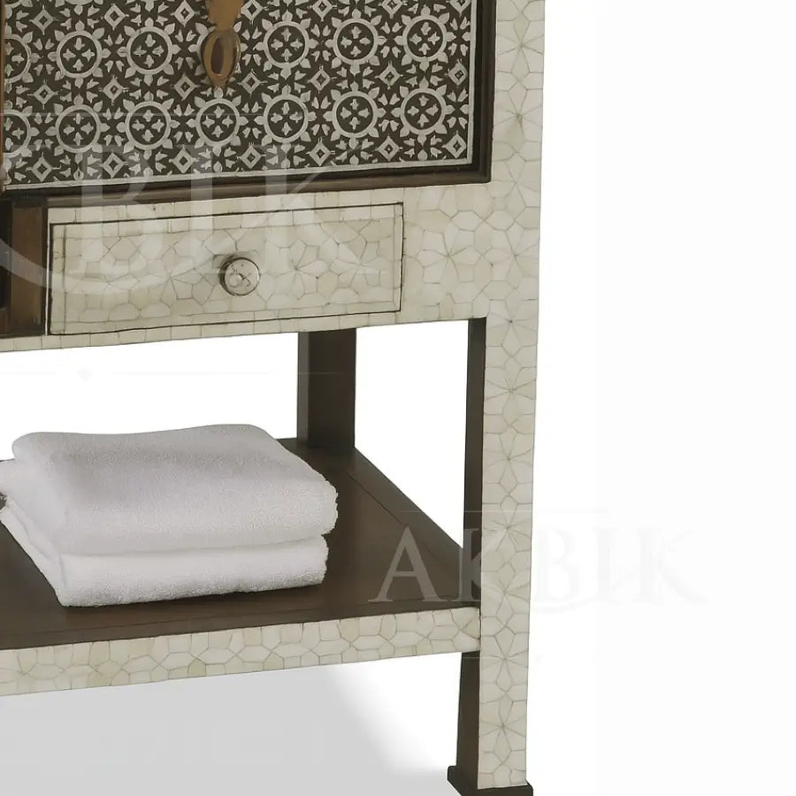 Decorative cabinet with patterned design and folded towels on a shelf