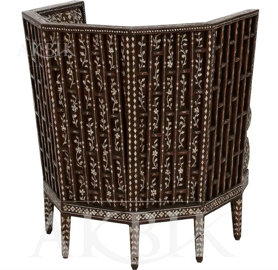 Back View of a decorative armchair with intricate floral patterns on a mother of pearl inlay background by Akbik Furniture & Design 