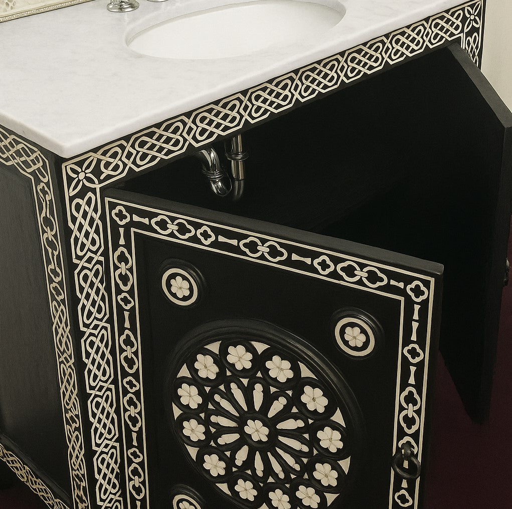 Black bathroom vanity with intricate mother of pearl patterns and a white cararra top