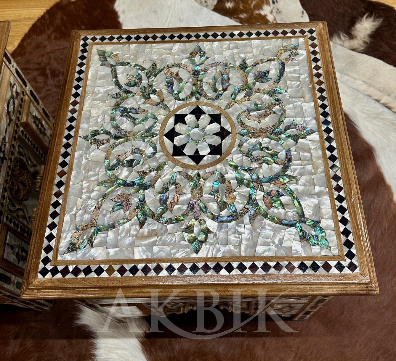 Decorative box with intricate mosaic design on a brown surface